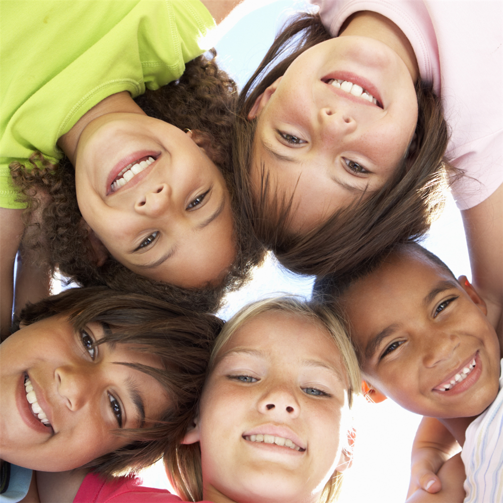  children's faces in huddle